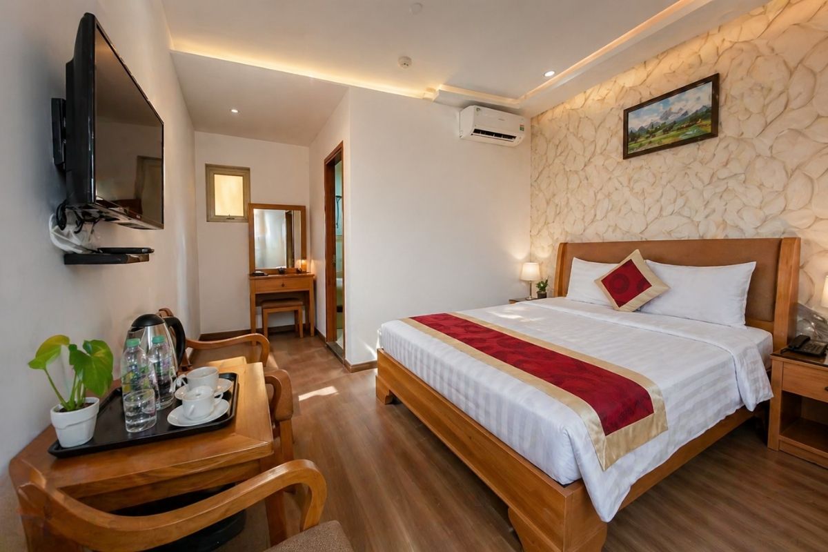 cozy guest room at The Airport Hotel with a large bed and wooden furniture