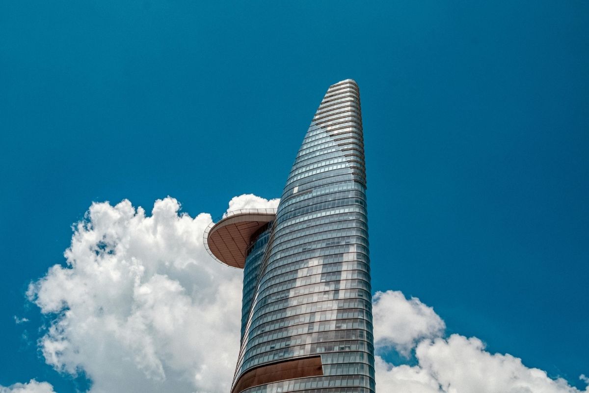tòa nhà bitexco tower dưới bầu trời xanh với mây trắng phía sau